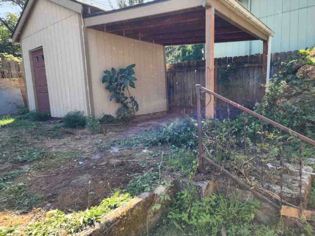 Clear and restored side yard area after 503 Clutter Busters removed all yard debris and abandoned items, ready for property turnover.